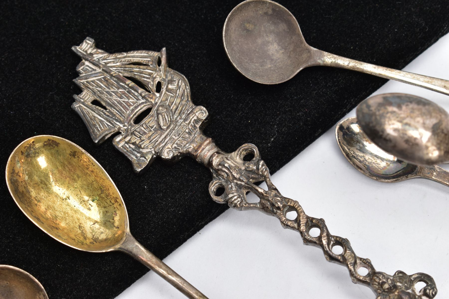 A BAG OF SILVER AND WHITE METAL SPOONS AND A PAIR OF SUGAR TONGS, to include four Georgian old - Image 2 of 4