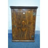 A GEORGE II WALNUT HANGING CORNER CUPBOARD, the quarter veneered door with crossbanded border,