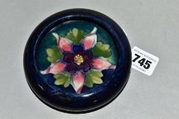 A MOORCROFT POTTERY SMALL CIRCULAR BOWL WITH SCROLL OVER RIM, decorated with a pink / purple