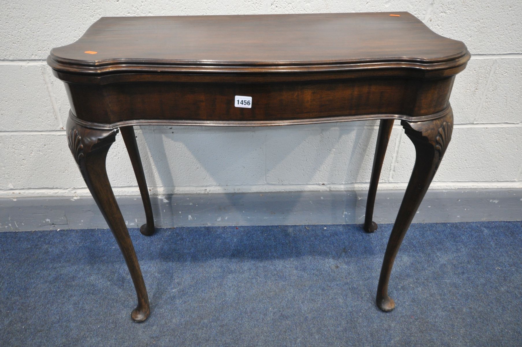 A 20TH CENTURY MAHOGANY CARD TABLE, in the Georgian style, the fold over top enclosing a green baize