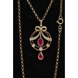 A MODERN 9CT GOLD RUBY AND DIAMOND PENDANT NECKLACE, openwork circular pendant with a diamond