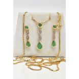 AN EMERALD AND DIAMOND PENDANT AND CHAIN, the yellow metal drop pendant set with a circular cut