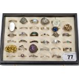 A RING BOX WITH ASSORTED SILVER AND WHITE METAL RINGS, black ring display case opens to reveal