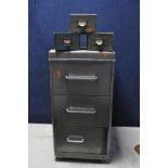 A METAL THREE DRAW FILING CABINET along with three cardboard organizers a vintage hole punch and a