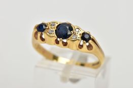 AN 18CT GOLD SAPPHIRE AND DIAMOND RING, designed with three graduated blue sapphires, interspaced