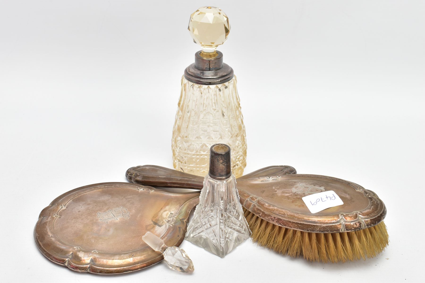 A SILVER VANITY HAIR BRUSH AND MIRROR WITH TWO SILVER MOUNTED SCENT BOTTLES, the hair brush of a