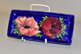 A MOORCROFT POTTERY ANENOME PATTERN TRAY, rectangular tray with tubelined red/purple anemones on a