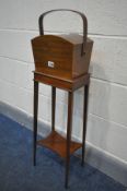 AN EDWARDIAN MAHOGANY SEWING BOX, on a square tapered stand united by an undershelf, width 26cm x