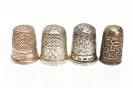 FOUR THIMBLES, to include a 'Charles Horner' thimble hallmarked Chester 1906, 4.8 grams, one stamped