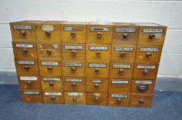 THIRTY EARLY 20TH CENTURY OAK APOTHECARY DRAWERS, majority of drawers with glass chemist labels (