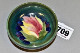 A MOORCROFT LEAF AND BERRY PATTERN FOOTED BOWL, impressed marks to the base, approximate diameter