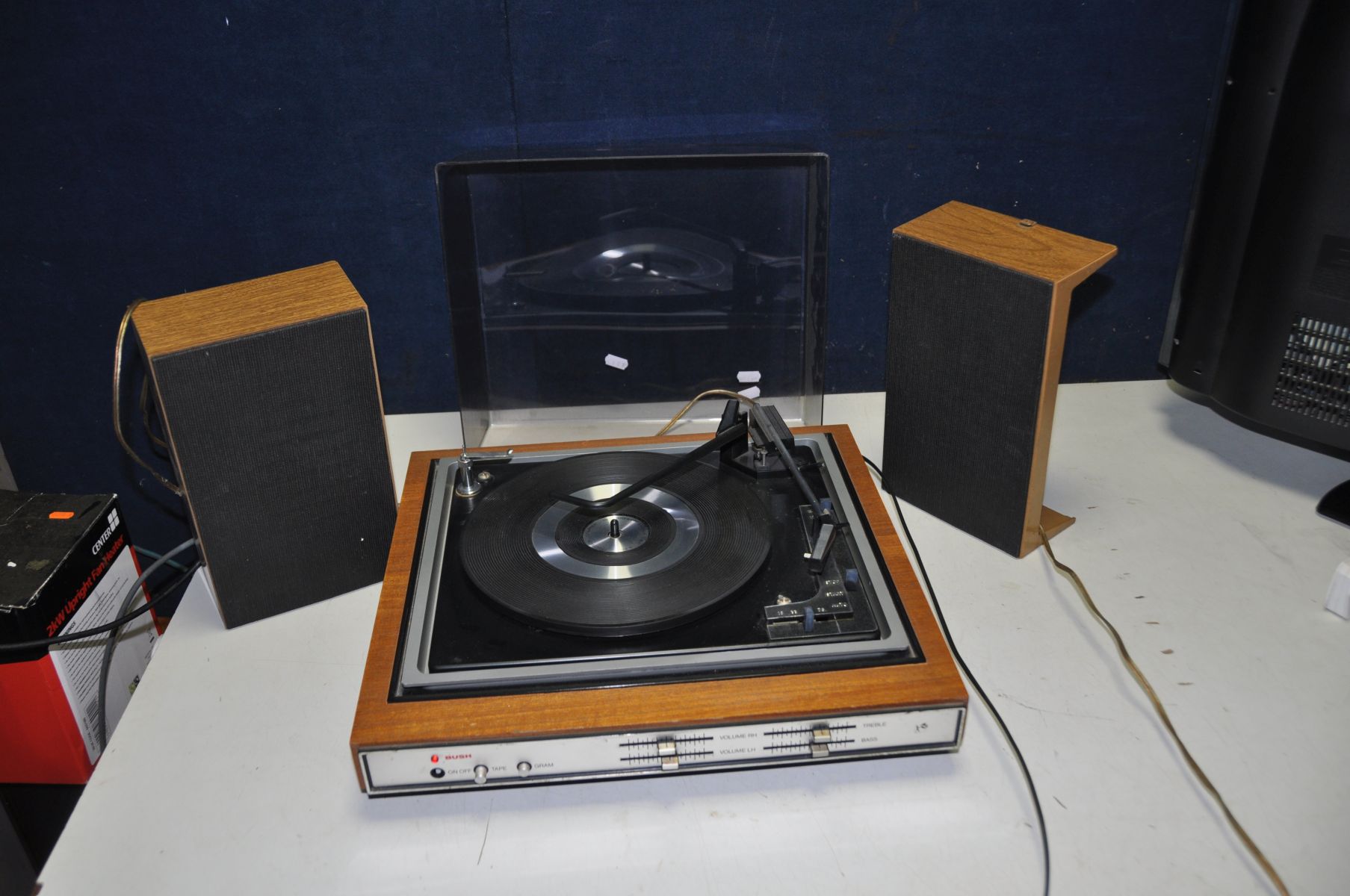 A VINTAGE BUSH A1005 RECORD PLAYER and a pair of speakers (PAT fail due to uninsulated plug but