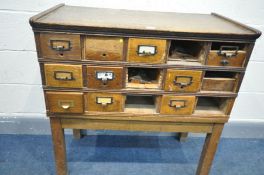 AN EARLY 20TH CENTURY OAK INDEX CABINET, made up for a possible fifteen drawers, on a square block