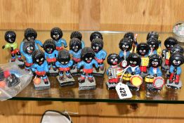 TWENTY FOUR ROBERTSONS FIGURES, comprising thirteen plaster jazz band figures (one has head