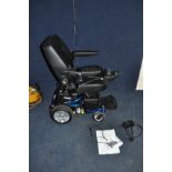 A ROMA ELITE P325 ELECTRIC WHEELCHAIR with power supply manual and original sales receipt (dated