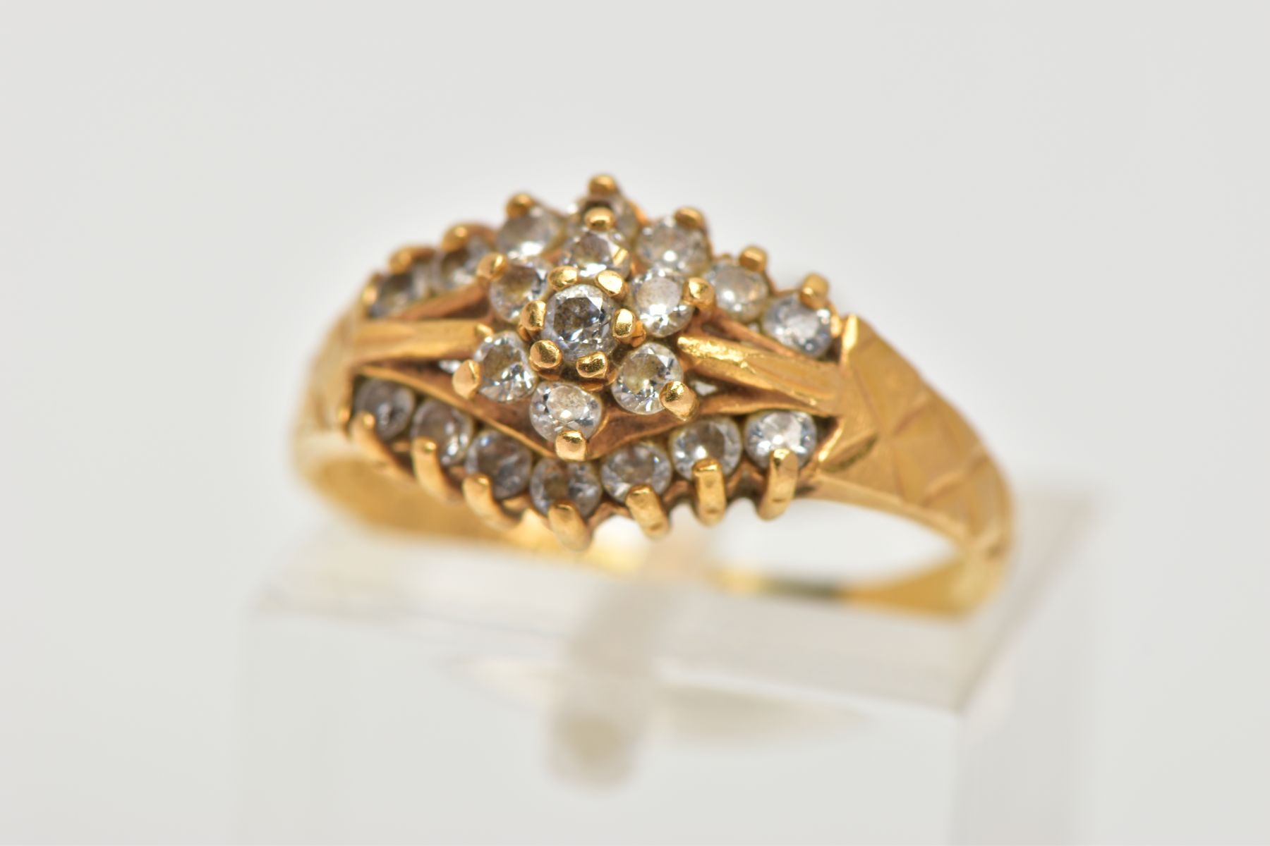 A 22CT GOLD CUBIC ZIRCONIA DRESS RING, set with a flower cluster of colourless cubic zirconia