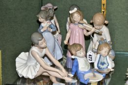 EIGHT NAO FIGURES OF CHILDREN, including a ballerina seated on the ground, a girl with a violin
