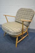 AN ERCOL WINDSOR BLONDE ARMCHAIR, with loose tartan cushions (the cushions do not comply with the
