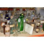 A COLLECTION OF ASSORTED CLEAR AND COLOURED GLASS PHARMACY JARS AND BOTTLES, ETC, including items