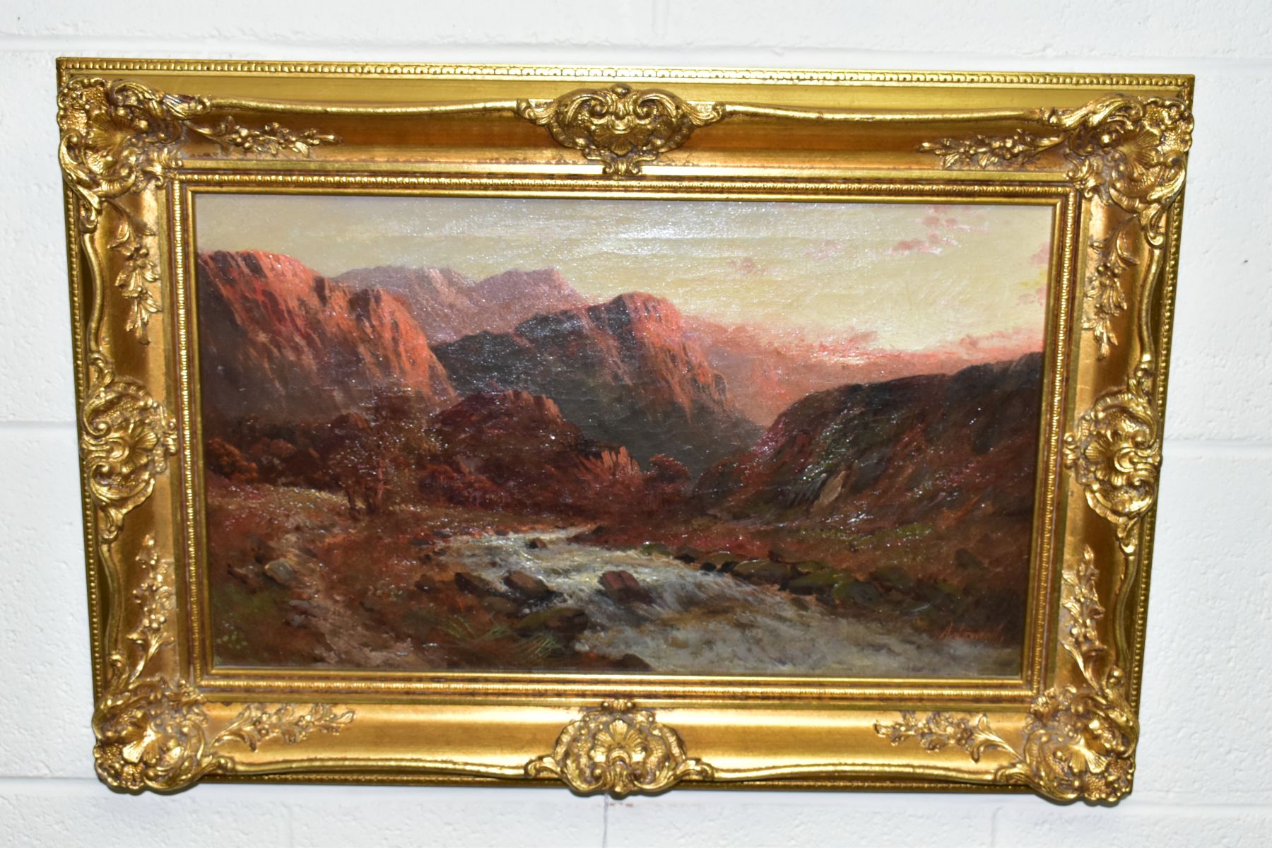 A. LEWIS (19TH/20TH CENTURY) A MOUNTAINOUS LANDSCAPE AT SUNRISE, fast flowing stream to the