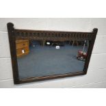 A MID CENTURY OAK WALL MIRROR, with carved top rail, 84cm x 57cm