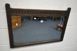 A MID CENTURY OAK WALL MIRROR, with carved top rail, 84cm x 57cm
