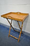 AN EARLY 20TH CENTURY OAK BUTLERS TRAY, on a folding stand, width 70cm x depth 49cm x height 86cm