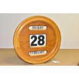 A MID 20TH CENTURY PALE OAK CIRCULAR CASED PERPETUAL WALL CALENDAR, diameter 30cm (Condition report: