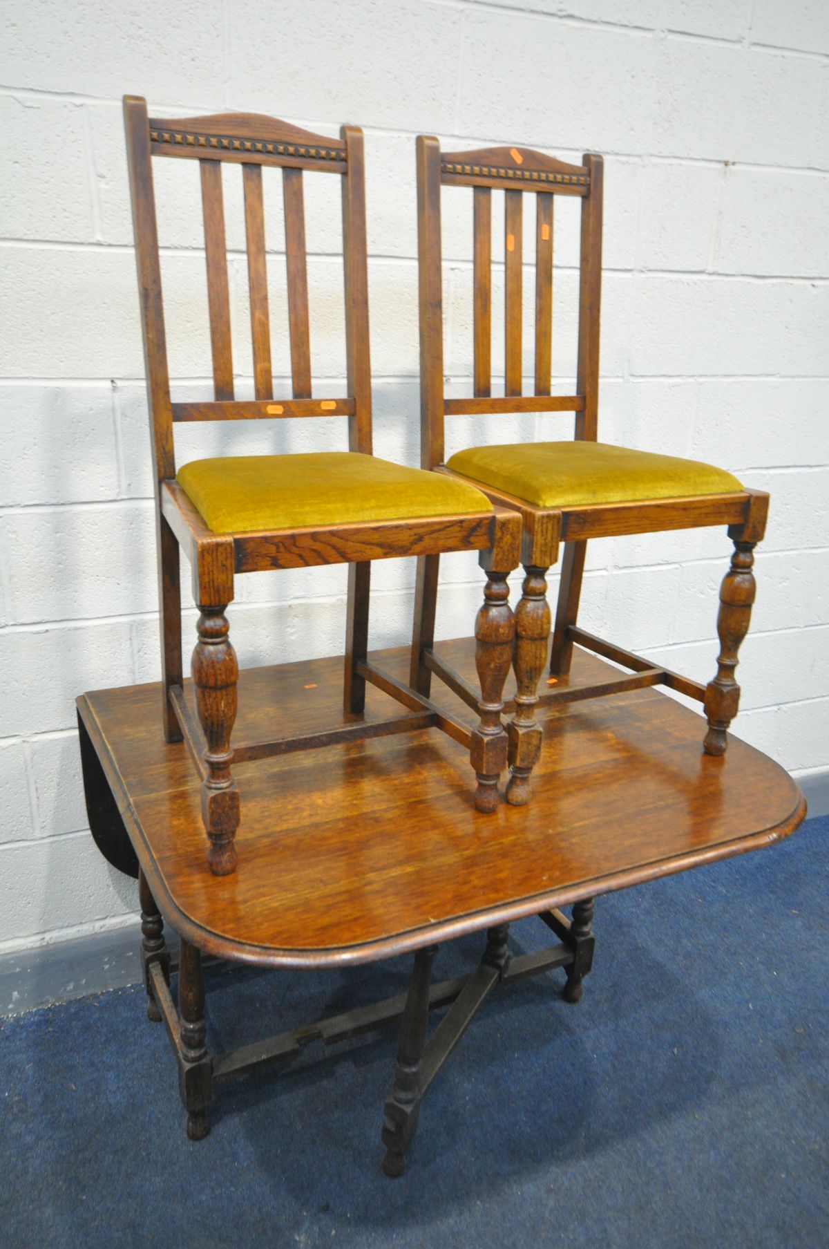 AN OAK GATE LEG TABLE, open length 137cm x closed length 49cm x depth 105cm x height 73cm, and two