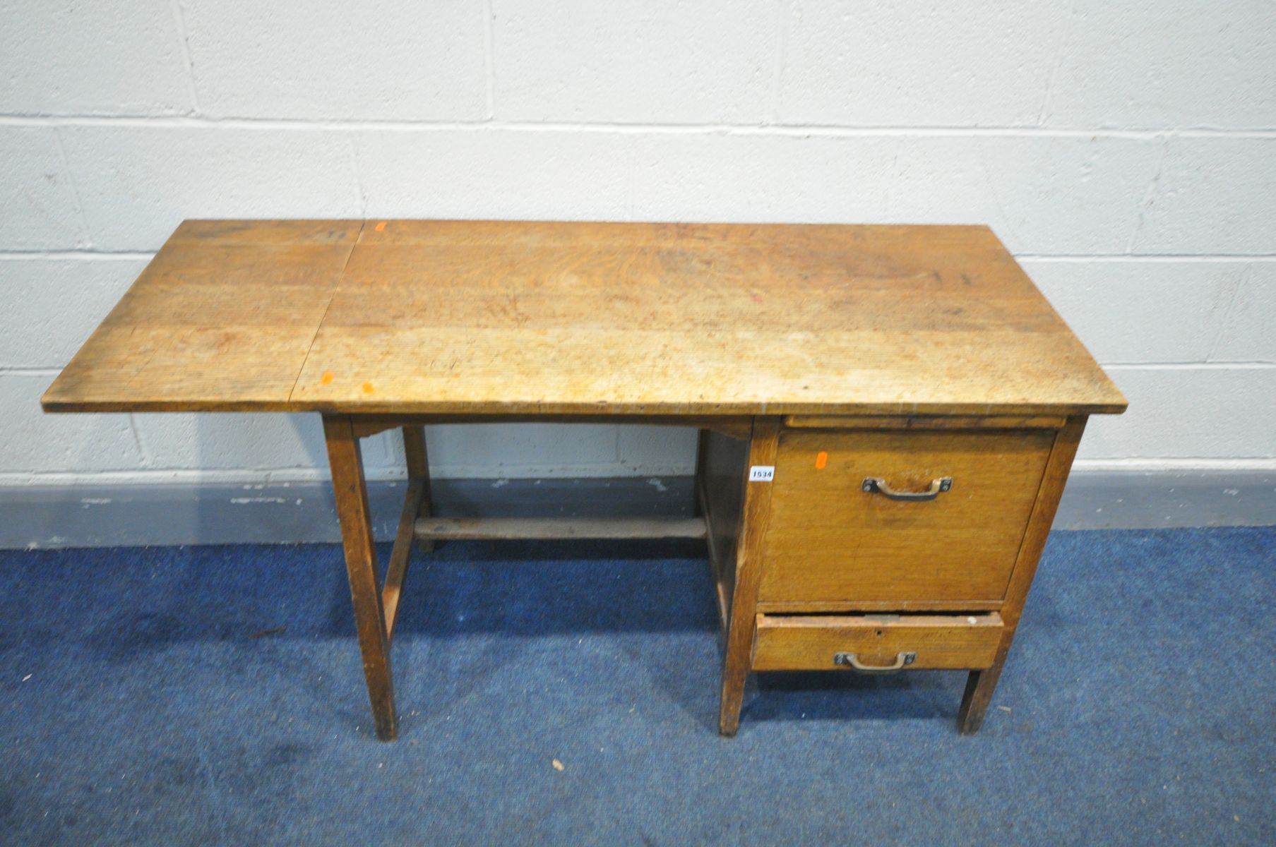 AN EARLY 20TH CENTURY 'SHANNON' OAK DESK, with a drop end, brushing slide, fall front filing door