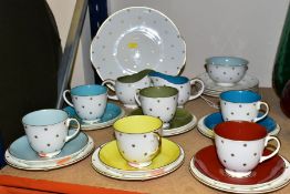 A TWENTY SEVEN PIECE SUSIE COOPER TEA SET, in Gold Star pattern, each cup having a different solid