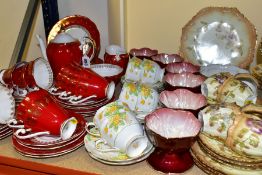 A SET OF SIX MALING RED LUSTRE SUNDAE DISHES AND THREE PART TEA SETS, comprising a fourteen piece