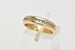 AN 18CT GOLD DIAMOND HALF ETERNITY RING, designed with a row of channel set round brilliant cut