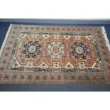 A SECOND HALF 20TH CENTURY CAUCASION SHIRVAN STYLE RUG, the triple medallion centre within a multi