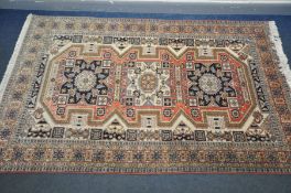 A SECOND HALF 20TH CENTURY CAUCASION SHIRVAN STYLE RUG, the triple medallion centre within a multi