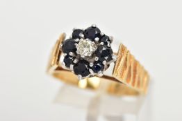 A YELLOW METAL SAPPHIRE AND DIAMOND CLUSTER RING, a single round brilliant cut diamond set within