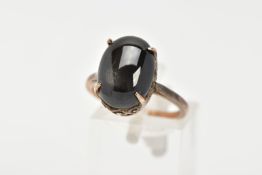 A YELLOW METAL STAR SAPPHIRE DRESS RING, an oval cut black star sapphire cabochon, approximate