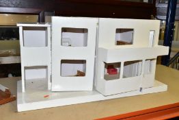 A TRIANG ULTRA MODERN DOLLS HOUSE AND TOY GARAGE, comprising dolls house in need of restoration