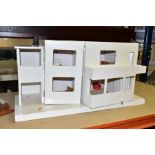 A TRIANG ULTRA MODERN DOLLS HOUSE AND TOY GARAGE, comprising dolls house in need of restoration