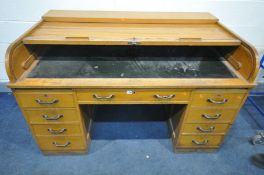 AN EARLY TO MID 20TH CENTURY OAK TAMBOUR TOP DESK, with nine various drawers, width 153cm x depth