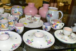 A QUANTITY OF POOLE POTTERY EGG CUPS AND OTHER PIECES, to include eight complete egg cup sets,