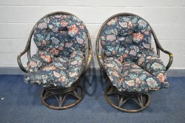 A PAIR OF BAMBO SWIVEL ROCKING CHAIR, with floral upholstery cushion