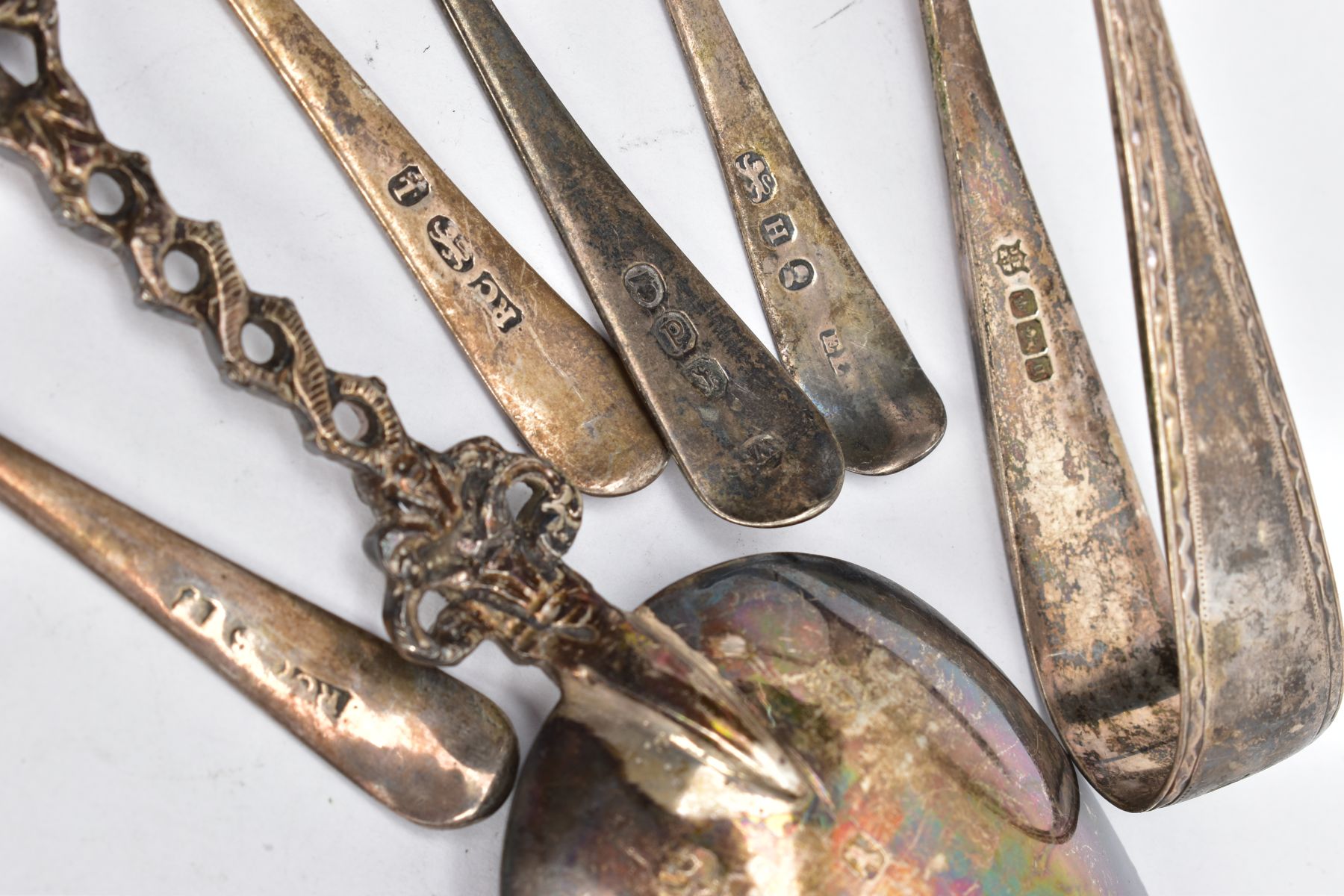 A BAG OF SILVER AND WHITE METAL SPOONS AND A PAIR OF SUGAR TONGS, to include four Georgian old - Image 4 of 4