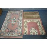 A PINK CHINESE WOOLLEN RUG, 153cm x 92cm, and three other rugs (4)