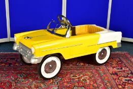 A YELLOW PEDAL CAR, modelled as a 1955 Chevrolet Bel Air convertible, unmarked, featuring a yellow