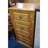 A LIGHT WOOD FOUR DRAWER FILING CABINET