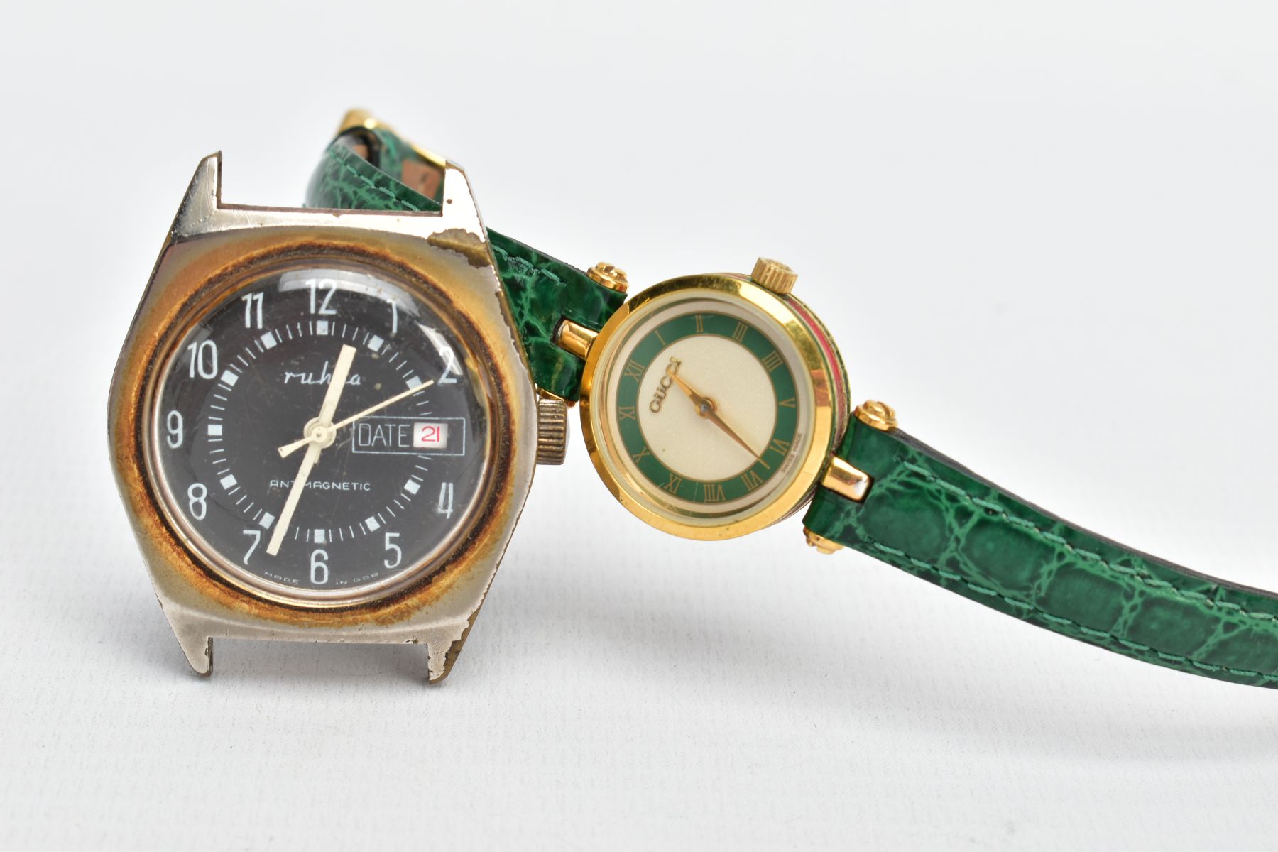 A GUCCI WRISTWATCH WITH ONE OTHER, round shimmer dial with a green border, signed 'Gucci', Roman
