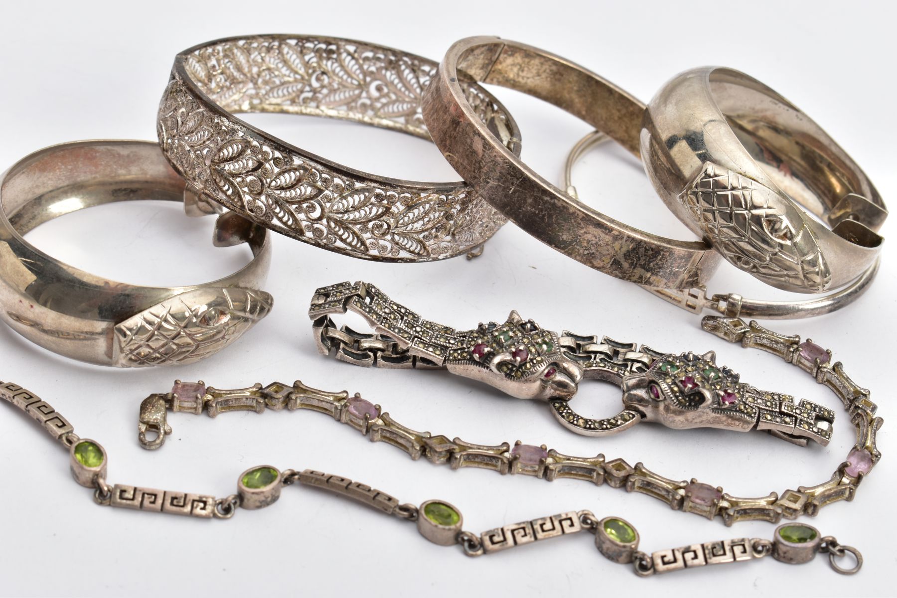 SIX BRACELETS AND A PAIR OF HOOP EARRINGS, to include a silver double jaguar head bracelet set - Image 2 of 5