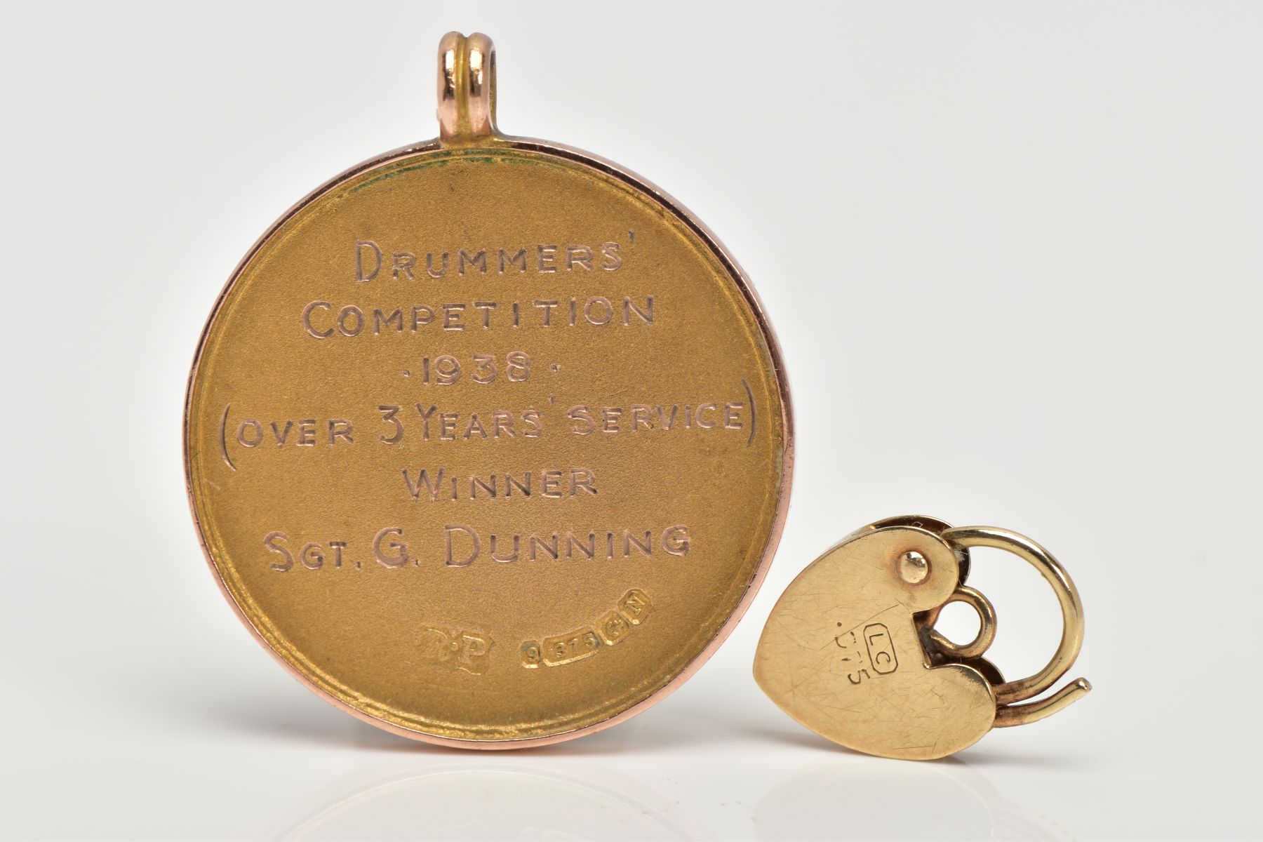 A 9CT GOLD MEDALLION AND YELLOW METAL CHARM, a yellow gold round medallion signed 'Duke of York's - Image 2 of 2