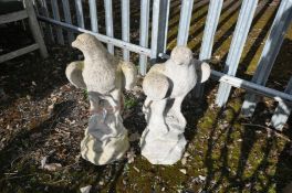 A PAIR OF COMPOSITE GARDEN FIGURES IN THE FORM OF EAGLES STANDING ON A ROCKPILE height 59cm (one